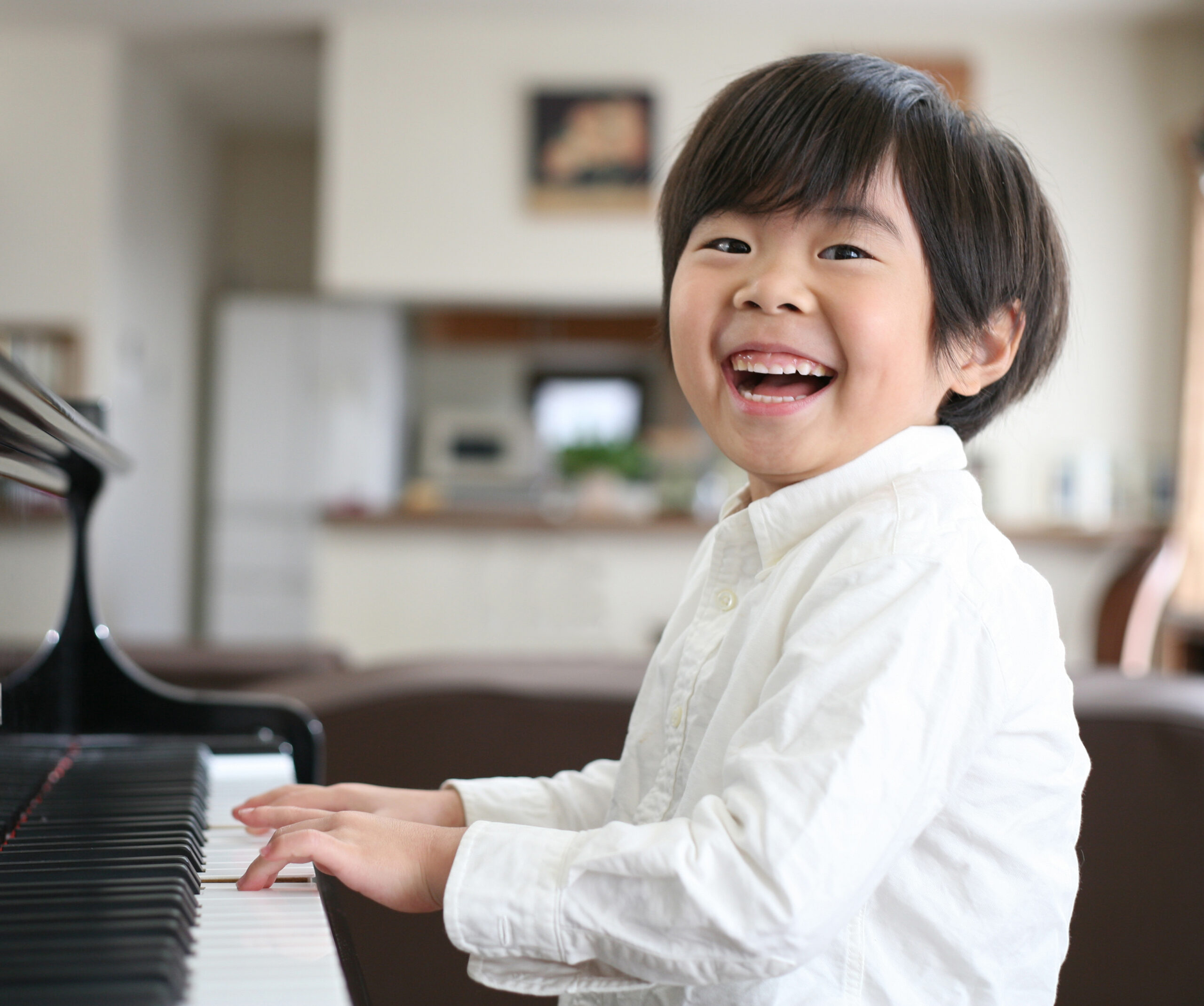 Happy boy playing piano